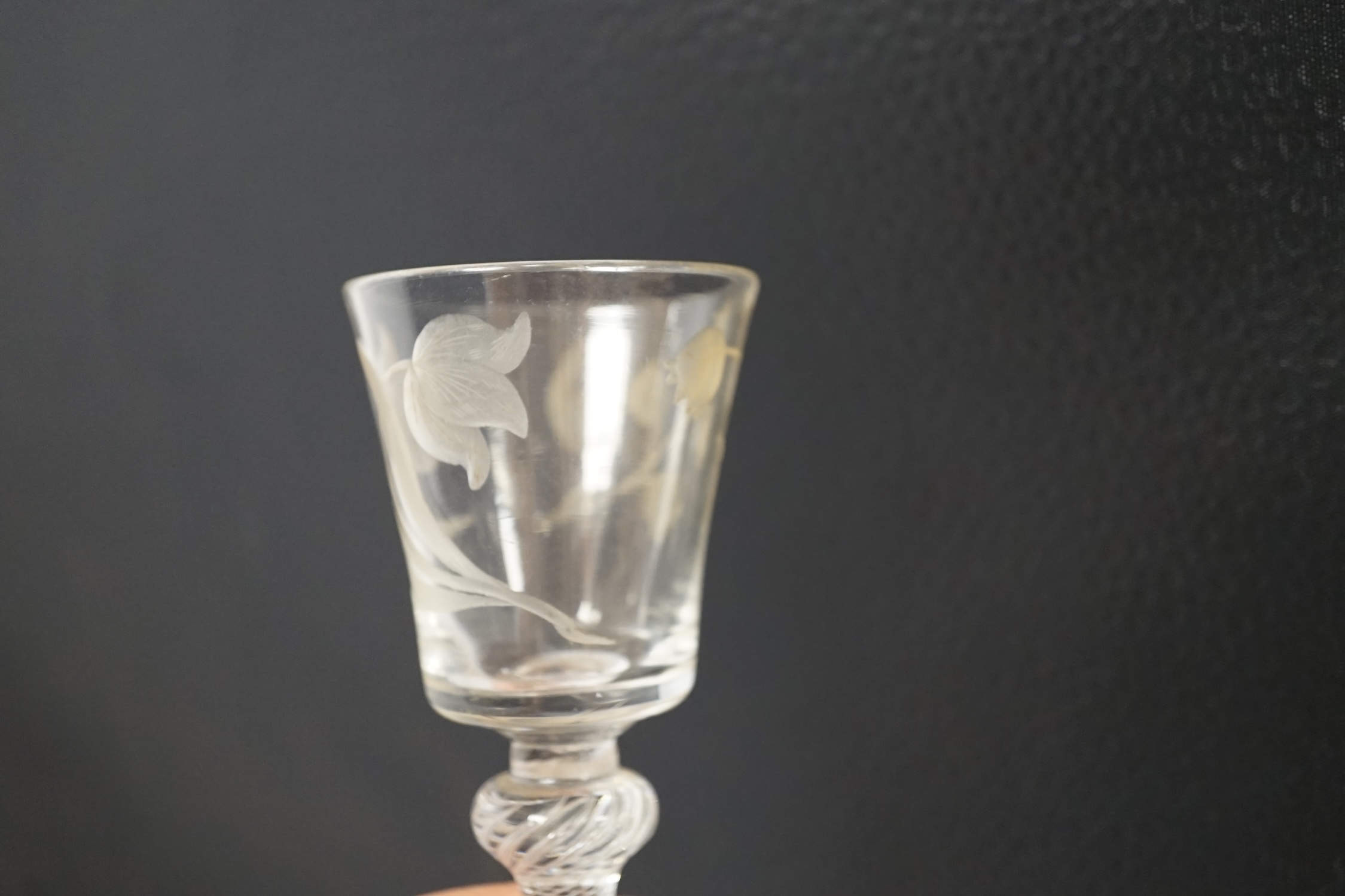 A mid 18th century air twist stem cordial glass with later engraved decoration, 15.5cm high. Condition - fair